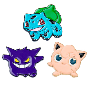 Two cute anime monster badges: blue-green with spiky hair and purple with pink accents