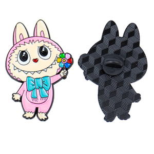 Hand holding a pair of cartoon rabbit lapel pins: a pink-clad rabbit with a white hat and its sleek black shadow counterpart